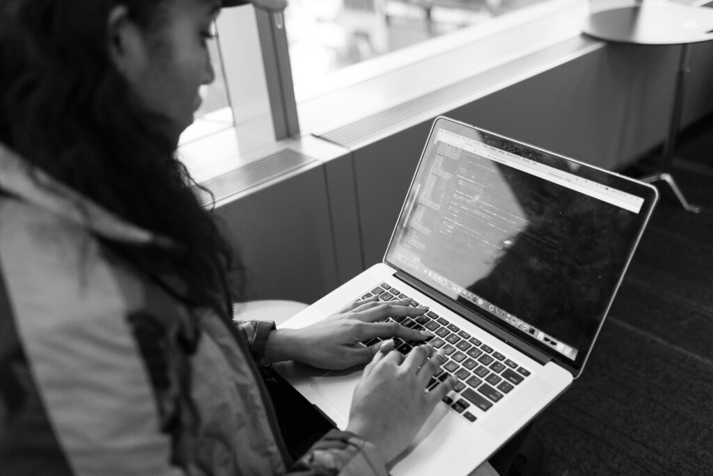 A woman working on her laptop — you don't need to become an AI expert to put AI to work.