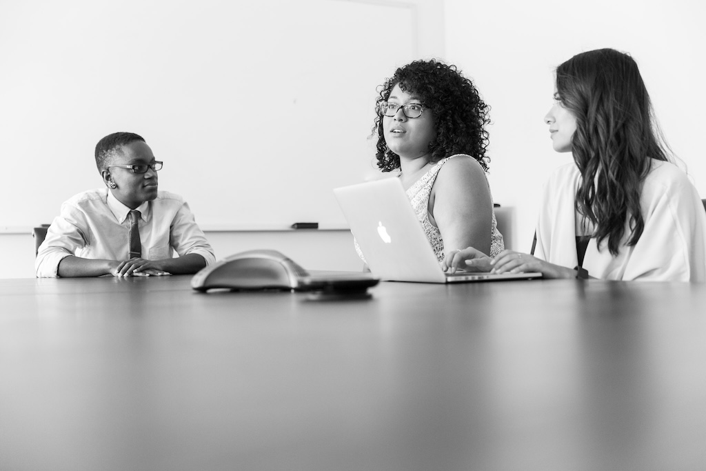 women answering a question in a meeting